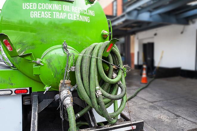 a grease trap pumping truck at a restaurant in Austin